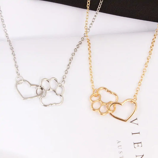 our Pet Paw Love Heart Necklace features a delicate hollow pet paw footprint pendant adorned with a sweet little heart.